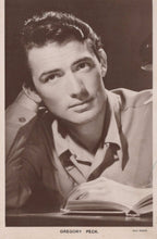 Load image into Gallery viewer, Vintage photograph of a man sitting at a desk with an open book, wearing a light-colored shirt.
