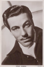 Load image into Gallery viewer, Black and white portrait of Cesar Romero with a blurred background
