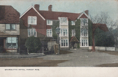 Vintage postcard of Brambletye Hotel in Forest Row with a red roof and white walls.