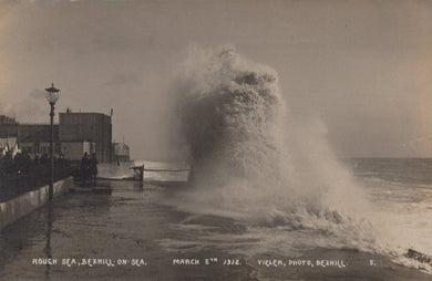 Vintage photograph of a stormy sea with waves crashing against a pier on March 5th, 1912.
