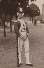 Load image into Gallery viewer, Person in a formal military uniform standing outdoors with trees and grass in the background
