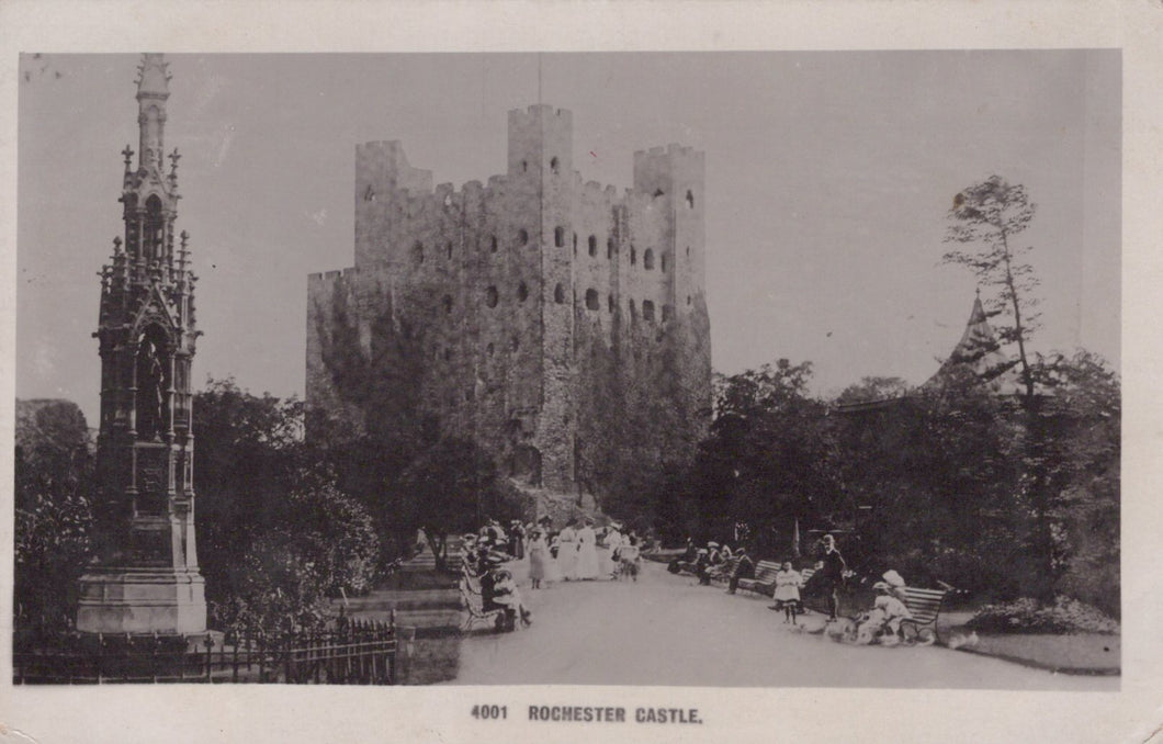 Vintage black and white photograph of Rochester Castle with people in the foreground.
