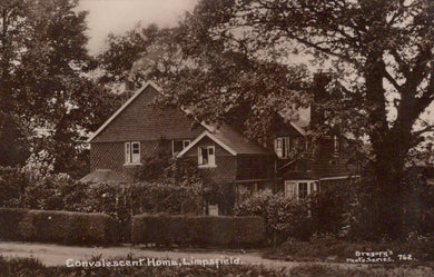 Vintage black and white photograph of a house with trees and garden