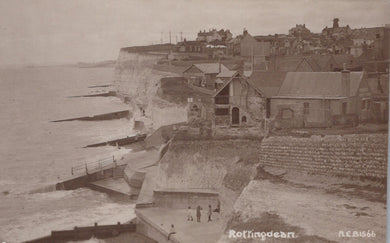 Vintage black and white photograph of coastal buildings and sea.