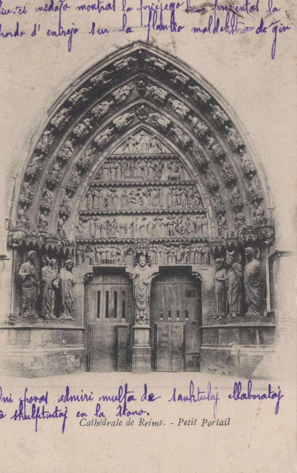 Gothic cathedral portal with intricate carvings and text on a vintage postcard.