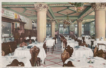 Load image into Gallery viewer, Vintage interior of a restaurant with tables, chairs, and decorative columns.
