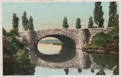 Stone bridge over a body of water with trees on either side, vintage style.