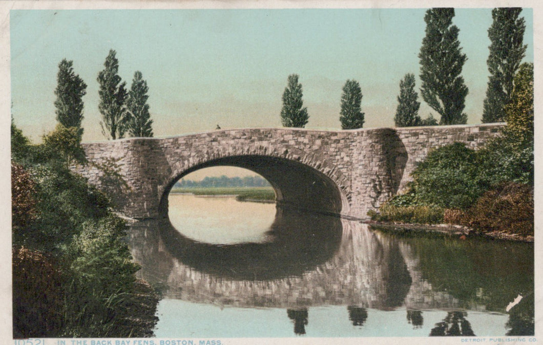 Stone bridge over a body of water with trees on either side, vintage style.