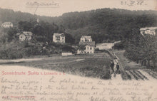 Load image into Gallery viewer, Vintage black and white photo of a village with houses and people on a path, dated 23. V. 06.

