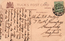 Load image into Gallery viewer, Vintage Tuck&#39;s postcard with text and a stamp on a brown background

