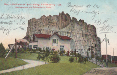 Vintage postcard of a building embedded in a rocky cliff with people around, labeled 'Deutschbähmische Ausstellung Reichenberg 1908'.