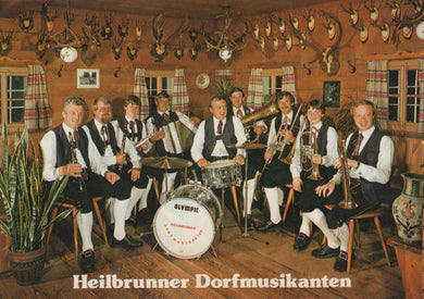 Band playing musical instruments in a room with hunting trophies