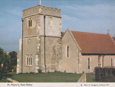 St. Mary's Church in East Ilsley with a clock tower and red roof.