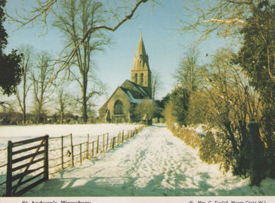 Snowy landscape with a church and wooden gate in the foreground