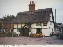 Load image into Gallery viewer, Traditional English pub with thatched roof in Tidmarsh, featuring a sign for &#39;The Greyhound&#39;.
