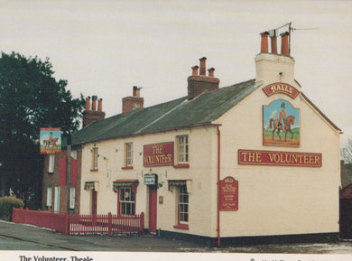 Pub named 'The Volunteer' with a horse and rider sign on a cloudy day.