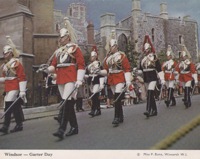 Historical military parade in Windsor with guards in red and white uniforms.