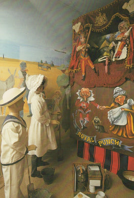 Vintage scene with people and a large mechanical figure labeled 'Royal Punch' in a decorated setting.