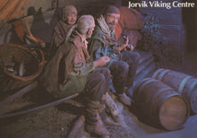 Load image into Gallery viewer, Illustration of three Vikings sitting around a fire with barrels and Viking gear in the background, labeled &#39;Jorvik Viking Centre&#39;.
