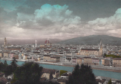 Cityscape with a river and mountains in the background