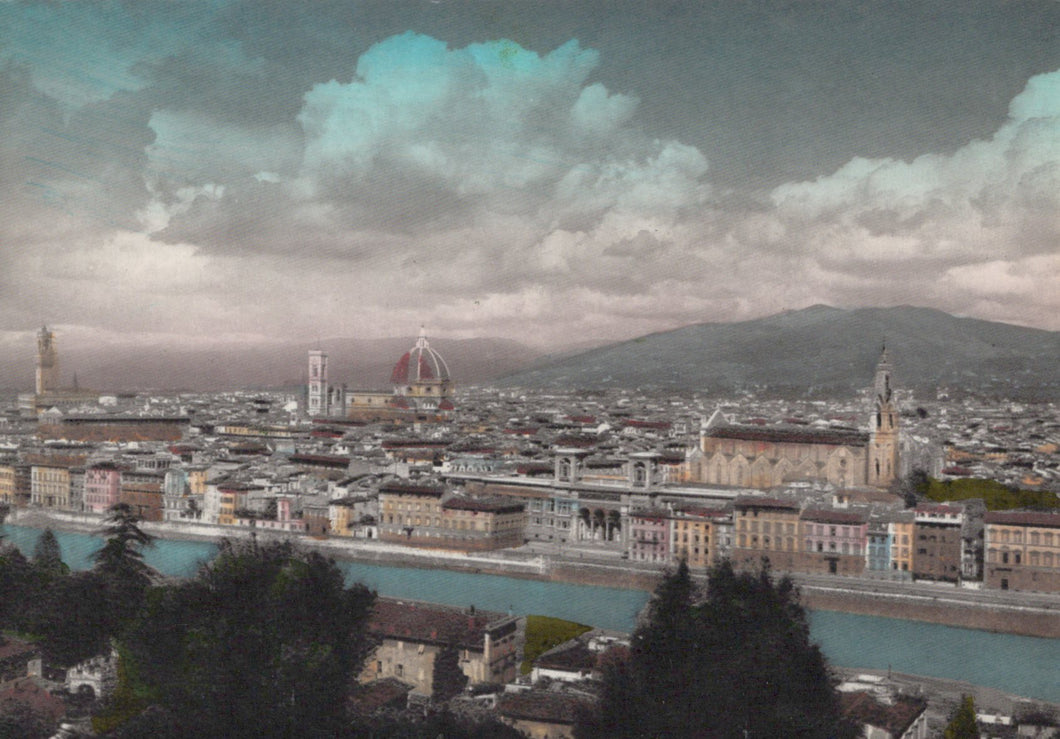 Cityscape with a river and mountains in the background