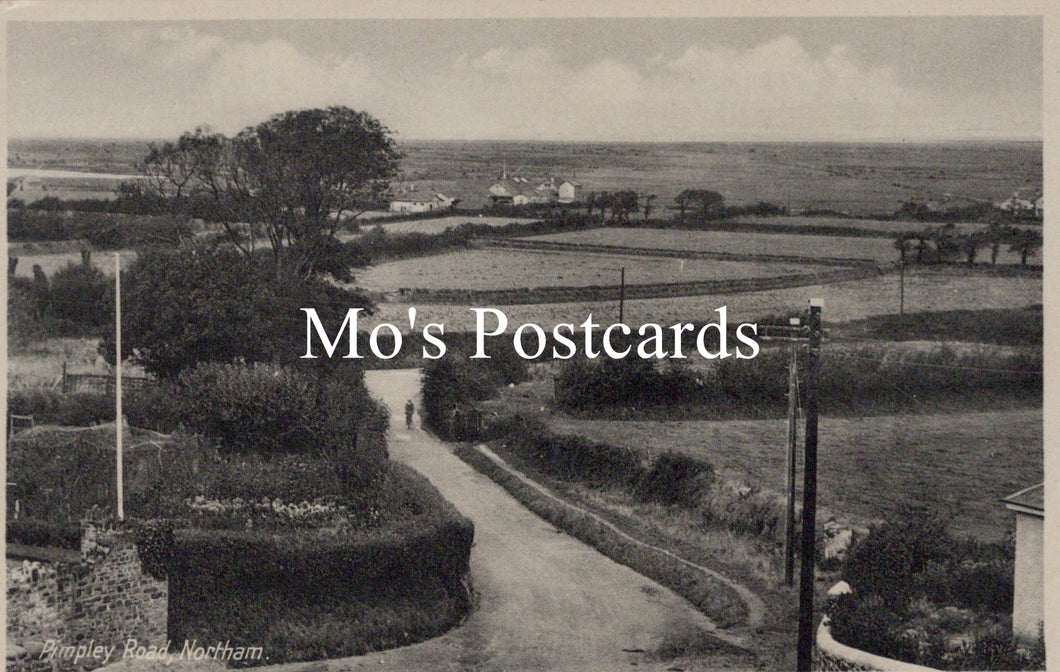 Vintage black and white photo of a rural landscape with a path and fields, featuring 'Mo's Postcards' text.
