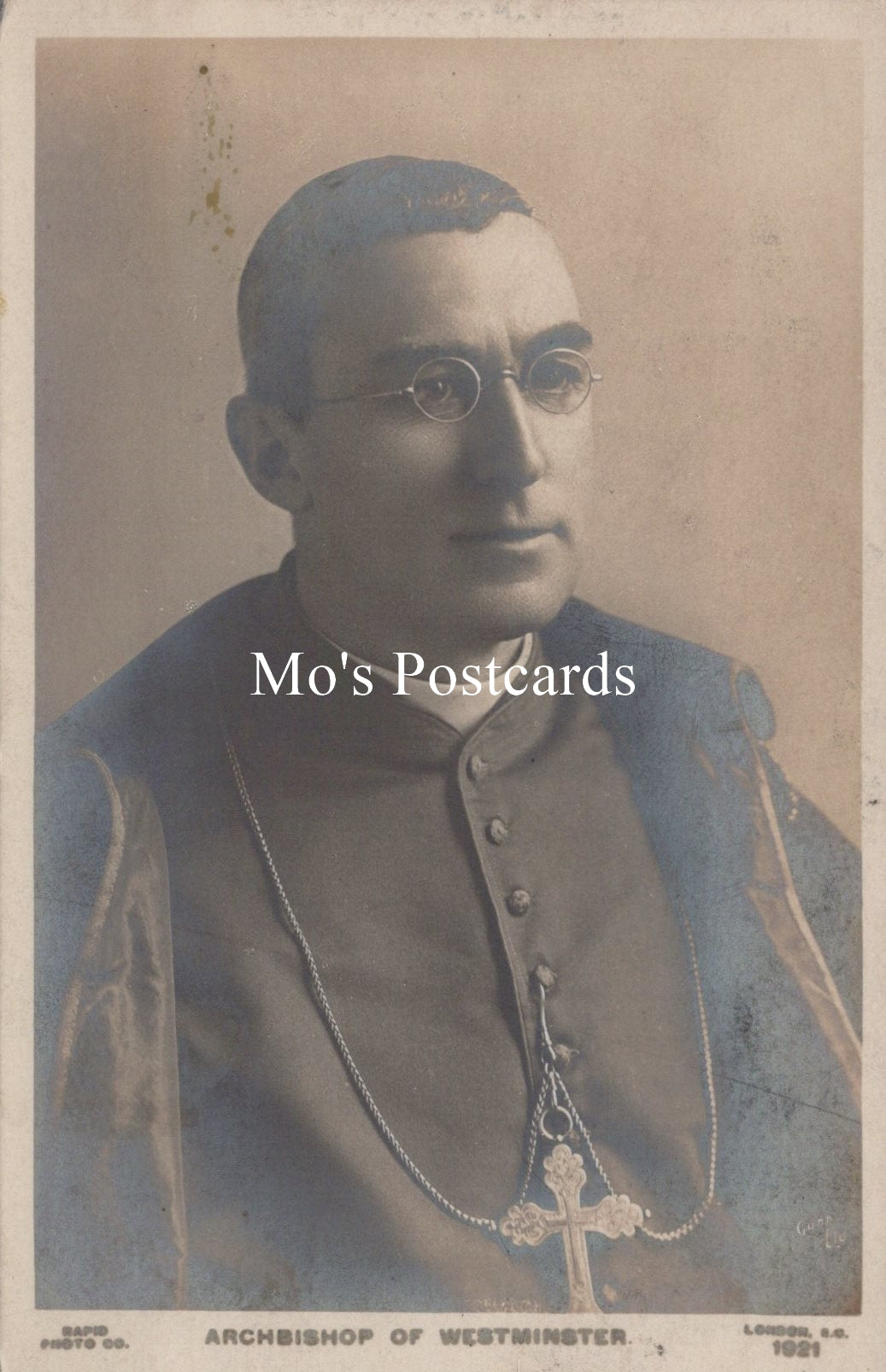 Vintage photograph of a man in religious attire with 'Mo's Postcards' text overlay.