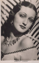 Load image into Gallery viewer, Vintage black and white portrait of a woman with decorative jewelry against a patterned background
