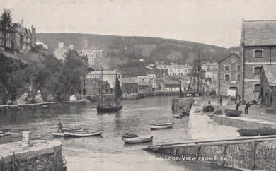 Vintage black and white photograph of a harbor scene with boats and buildings.