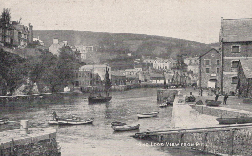 Vintage black and white photograph of a harbor scene with boats and buildings.