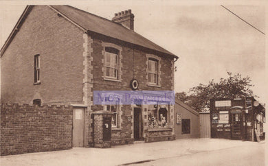 Vintage black and white photo of a two-story brick building with a sign on the front.