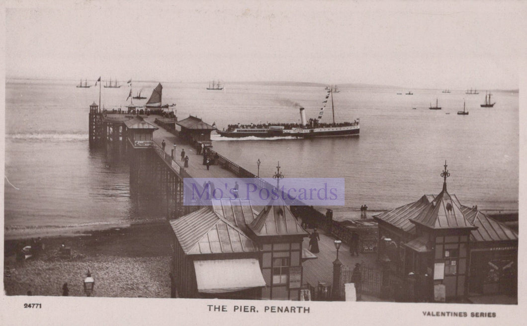 Vintage black and white postcard of a pier with boats and buildings, featuring 'Mo's Postcards' branding.