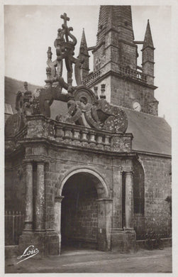 Decorative stone archway with intricate carvings in front of a building