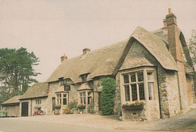Traditional stone building with a thatched roof in a rural setting