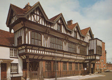 Load image into Gallery viewer, Traditional wooden building with a red roof against a blue sky.
