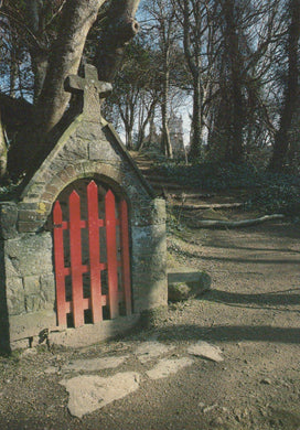 Stone gate with red gate in a forest setting