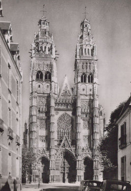 Historic cathedral with tall spires and intricate architecture, surrounded by buildings.