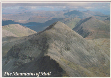 A scenic view of the Mountains of Mull with rolling hills and a cloudy sky.