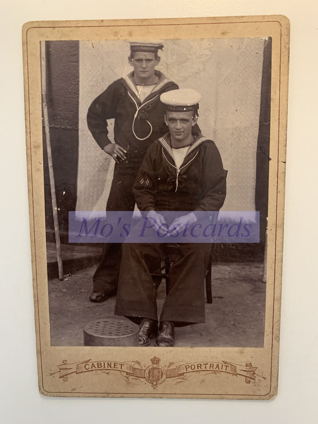 Vintage photo of two men in sailor outfits with a 'Cabinet Portrait' label.