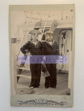 Vintage photograph of two sailors on a ship with 'M's Postcards' label.