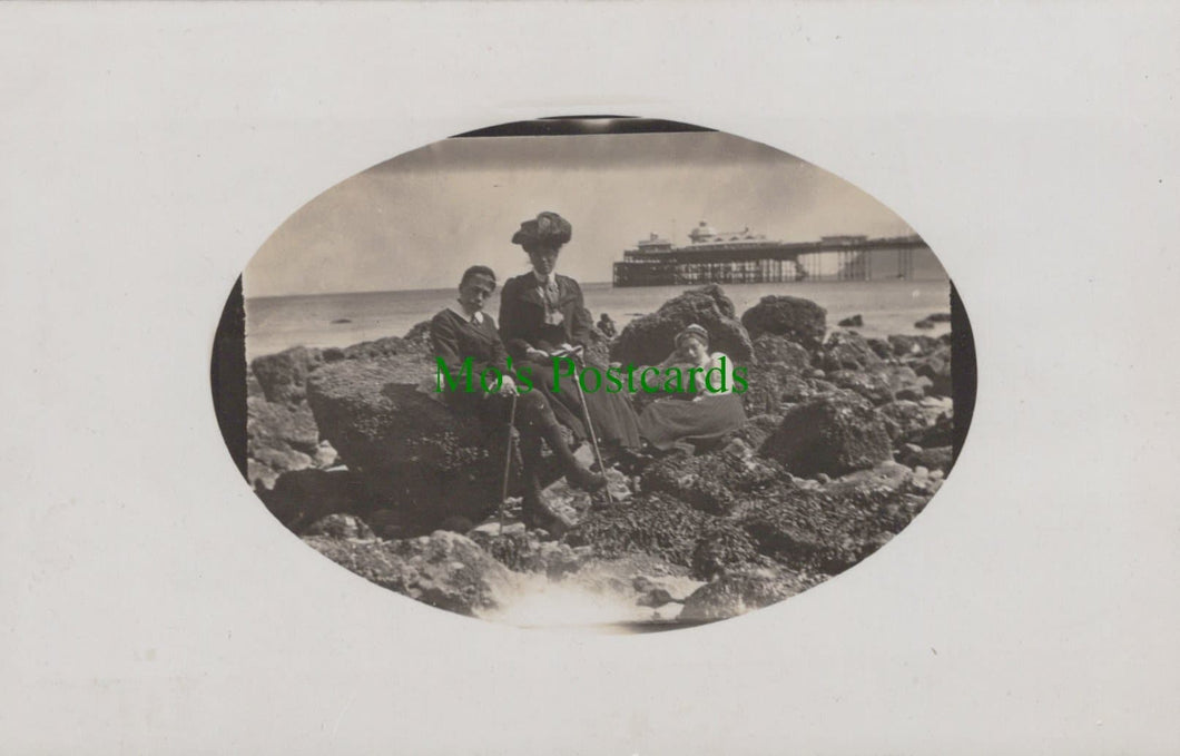 Mother and Children Sitting on Rocks at The Seaside